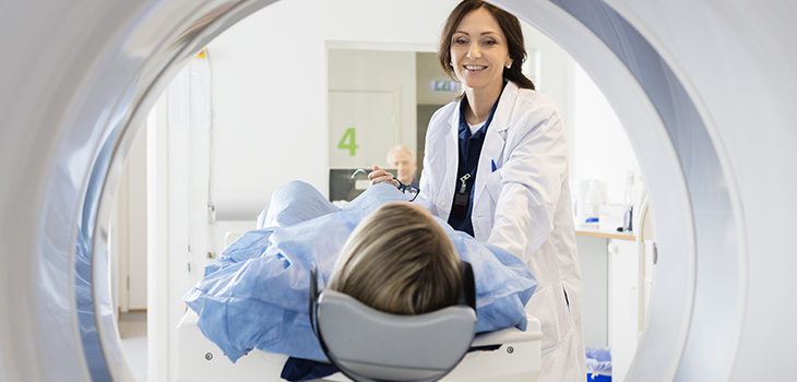Photo of a doctor preparing to bring a patient into a scanner. Shutterstock.