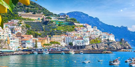 Panoramic view of the hills of Amalfi that descend to the coast. This Amalfi coast is the most popular tourist destination in Europe. Ripe yellow lemons in the foreground.