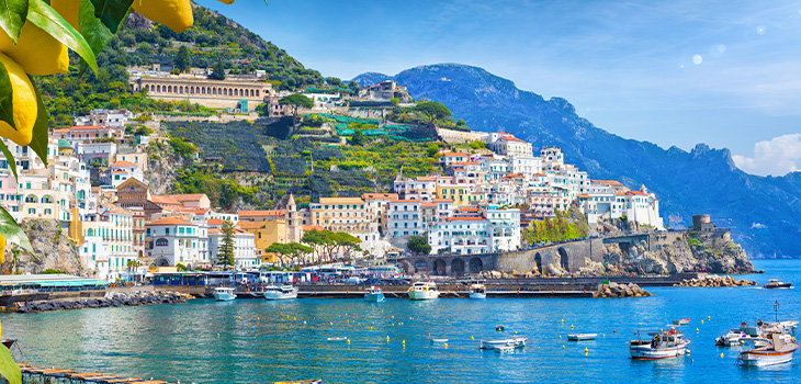 Panoramic view of the hills of Amalfi that descend to the coast. This Amalfi coast is the most popular tourist destination in Europe. Ripe yellow lemons in the foreground.
