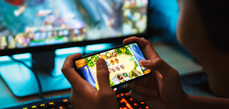 Photo d'une personne jouant à un jeu vidéo avec son téléphone cellulaire
